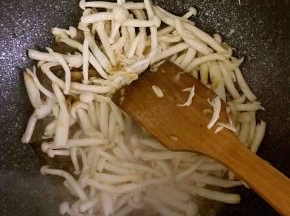 8.倒入白玉菇，并加入生抽，盐，黑胡椒翻炒