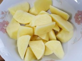 7.两个土豆去皮切滚刀块备用。
