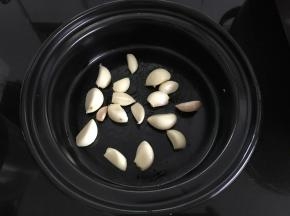 把剥好的大蒜放入酒精炉锅中。