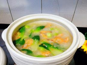 粥里加入青菜，虾，小火再煮5分钟即可