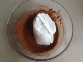 取1/3的打发好的蛋白霜放入到可可蛋黄糊里，从底部向上翻拌均匀