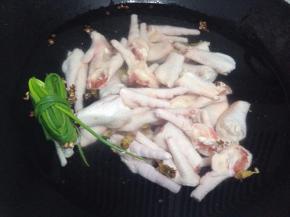 鸡爪冷水入锅，放姜葱，花椒及料酒中大火煮开转小火煮15至20分钟，