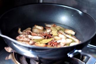 6、倒入开水要没过五花肉，然后放入桂皮、大料、香叶