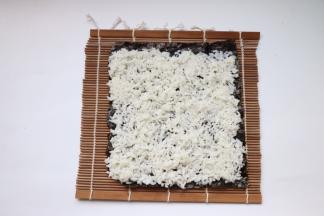 均匀铺上米饭，末尾留2厘米不放米饭，方便卷起来收口