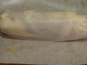 我是徒手卷起的，也可以借住擀面杖卷油纸一端卷起。放入冰箱冷藏2小时左右，比较好切。