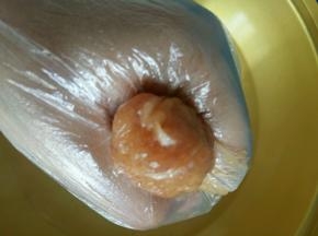 水开后开始挤丸子了。抓一把肉泥，在虎口出来回的挤几次，丸子就圆了，用勺子挖下来，放入锅中。