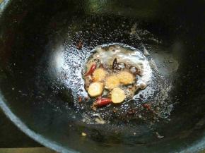 捞出虾，锅中留少许油，下辣椒、姜片、花椒炒香。