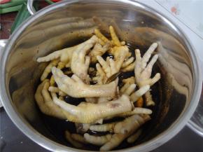 酱油烧开后，加入各样的调味料和鸡爪，用筷子翻转几下。