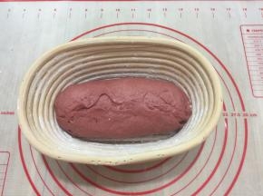 把揉好的面团光滑的一面朝下码在发酵篮里