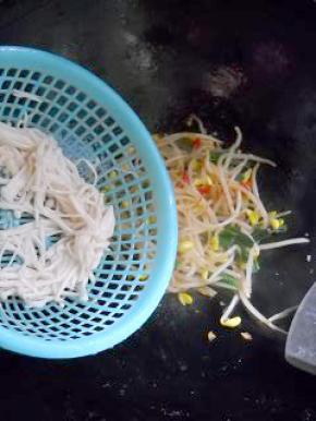 豆芽炒至八成熟，倒入金针菇，加入适量盐，炒匀。