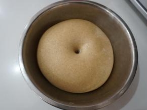 揉好的面团盖保鲜膜放在温暖处进行第一次发酵，发酵至手指蘸粉不会缩不塌陷