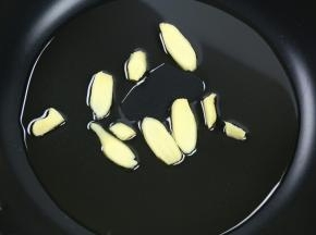 不粘锅里放入食用油，加入姜片，小火加热。