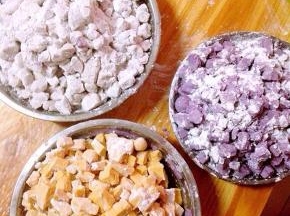 制作方法：蒸熟的果泥加入木薯淀粉，建议大家木薯粉不要一次性加足。可以先倒入一部分，先用筷子搅拌，待面团稍硬后再用手揉，揉搓成干的，有弹性的面团就算是成功了。芋头和紫薯会干一点，可以适量加一点水。芋头泥里面我还加入了少许黑芝麻。切丁的时候可以在案板和盘子上撒上少许面粉，防止芋圆粘连。