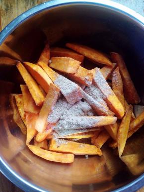 趁热倒入甘梅粉，上下左右晃动盆子，让每一条地瓜条都均匀的裹上甘梅粉。