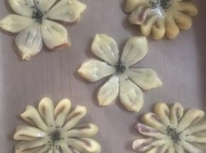做成菊花和紫荆花，刷上蛋液，撒上芝麻