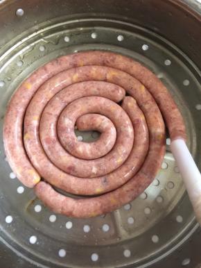 轻轻的旋动灌肠神器的手柄，肉馅就很轻松的灌进肠衣里面了！不要灌的太满，7分满即可！太满蒸的时候会涨破的哦  整齐的码放在蒸笼里面。
