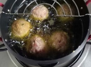 放入油锅，中小火慢炸，等肉圆凝固后，用筷子翻动肉圆，防止焦糊