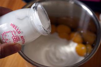 蛋黄中加入250克自制酸奶，充分搅拌均匀。