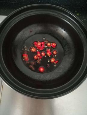 花椒出香味后，加入小米辣。