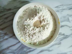 南瓜泥和紫薯泥分别加入白糖、面粉和酵母，用筷子搅拌成絮状