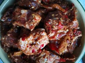 将腌好的肉均匀铺在土豆上面