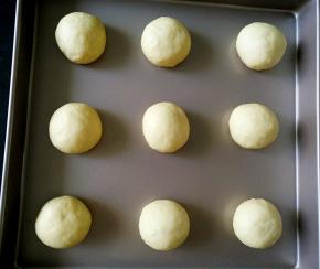 将面团平均分成18份，滚圆，摆入烤盘，放烤箱发酵