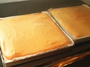 烤架上铺一层油纸，出炉的蛋糕片马上倒扣，这样表皮会被黏掉，卷起来就很白净了。