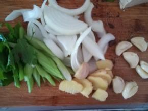 芹菜切断，洋葱切丝。生姜切片，大蒜拍扁去皮。