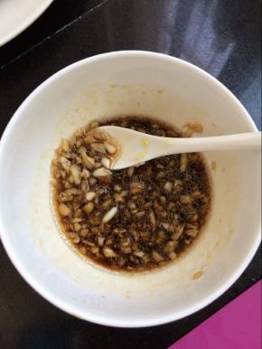 准备一个碗，放入切好的蒜末，姜末，加入醋，香油，鸡精，生抽、盐，搅拌匀