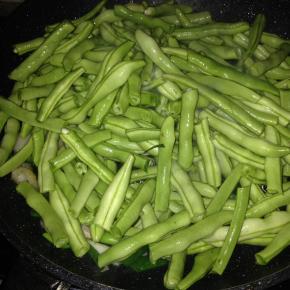 锅内倒入适量食用油，加入豆角翻炒。