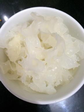 将银耳剪成小块，前一天晚上把银耳剪小后放进热水瓶里，然后冲入烧开的热水，第二天早上倒出来即可