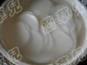 年糕切好片；用开水烫一会，沥干水分。