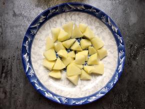 盘底铺上土豆（也可以铺南瓜、红薯，也可以不铺）。