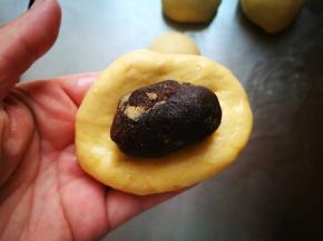 包入豆沙馅，不要太多，我每个放了15克左右，太多了面包烤时会裂开，包成椭圆形