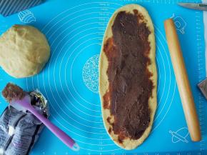 再把豆沙均匀涂抹在长条状，再卷回来