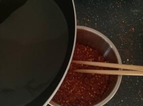 热油倒入辣椒面中。