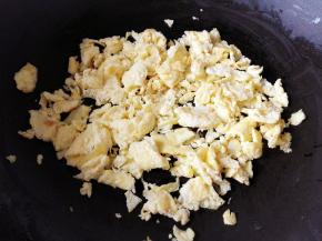 2.	鸡蛋打在碗里，加一点盐，搅打均匀，锅里放入稍微多一点的油，油热后倒入鸡蛋，炒熟，用铲子切成小块，放凉