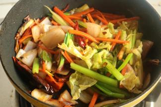 再下入其他蔬菜继续翻炒，加适量盐调味。