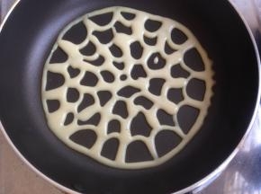 将面糊装进裱花袋中，剪个小小的口，然后在不粘锅里画图案