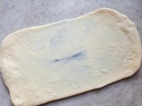 10.松弛五分钟后，用擀面杖将面擀成长方形。