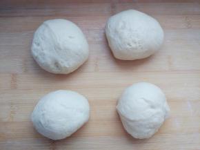 静置饧面10分钟后，借助厨房秤辅助，分成稍大的两块和稍小的两块。