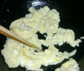 锅中倒油，下入鸡蛋液用筷子划散。