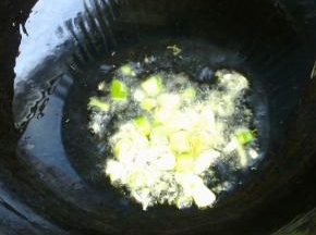 锅里中火爆香葱蒜。