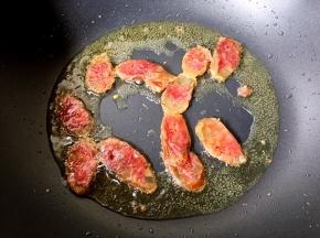 放入香肠翻炒片刻。