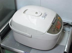 盖上电饭煲，启动煮饭，静待饭熟。