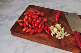 番茄对切，蒜切片，葱切小段，姜切片，辣椒切小段
