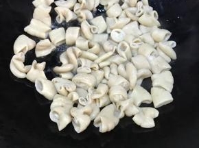 待油温升高，倒入肥肠。