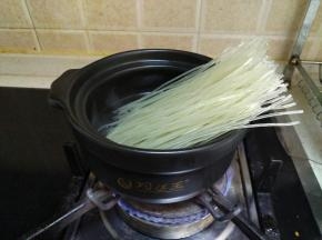 把粉丝和木耳放入砂锅里煮软。