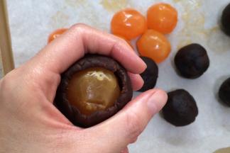 把豆沙分成8等份，每份是25克。取一份豆沙包入一个咸蛋黄，收好口。