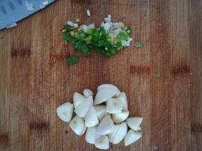 大蒜去皮，切个两刀，成块。小葱切段。